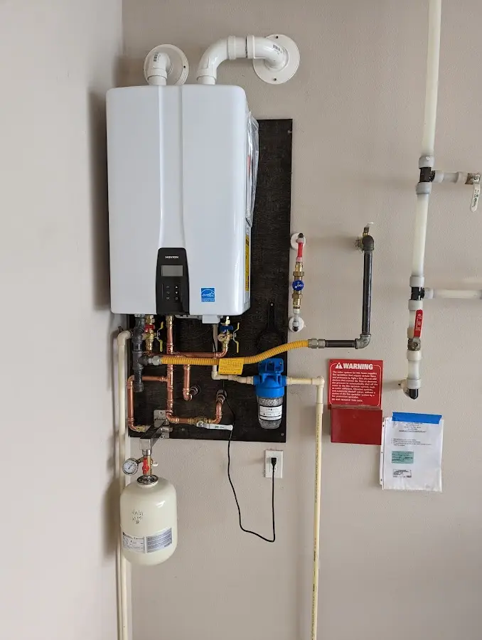 Professional plumber installing copper piping in a Lynn Haven home